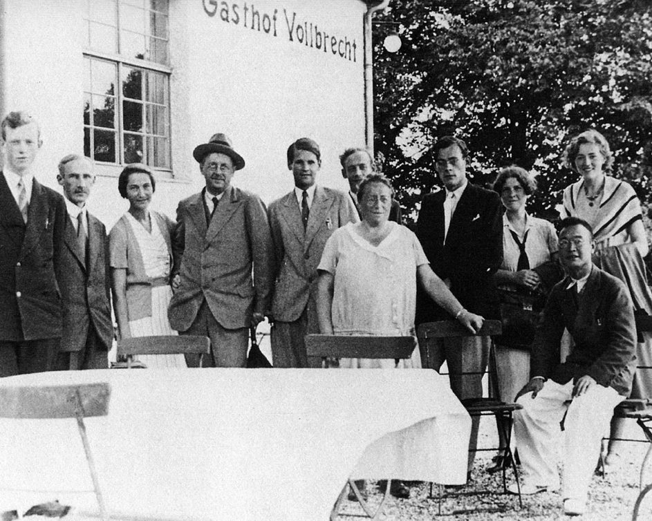A group of mathematicians outside a restaurant, smiling